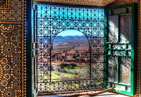 Mosaics and metal scrollwork window in Morocco