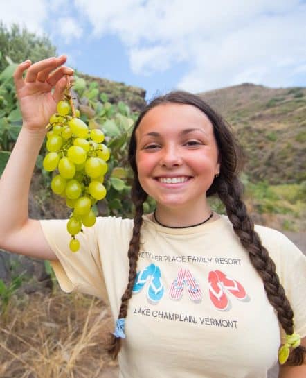 Female holding a bundle of grapes