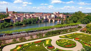Flower garden in France with city in background