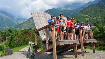 Group standing on a giant Adirondack chair in Sud Tyrol